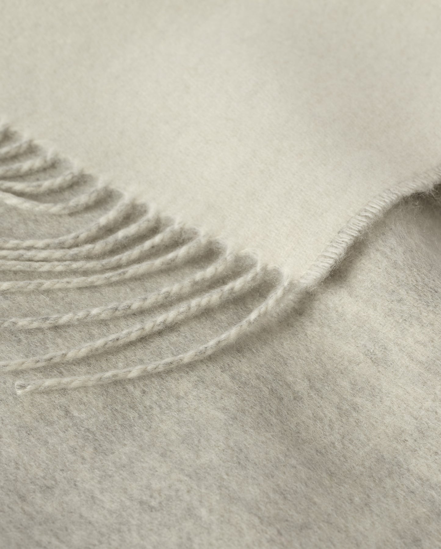 Johnstons of Elgin Light Grey & White reversible blanket on a grey background WA000013RU5059ONE