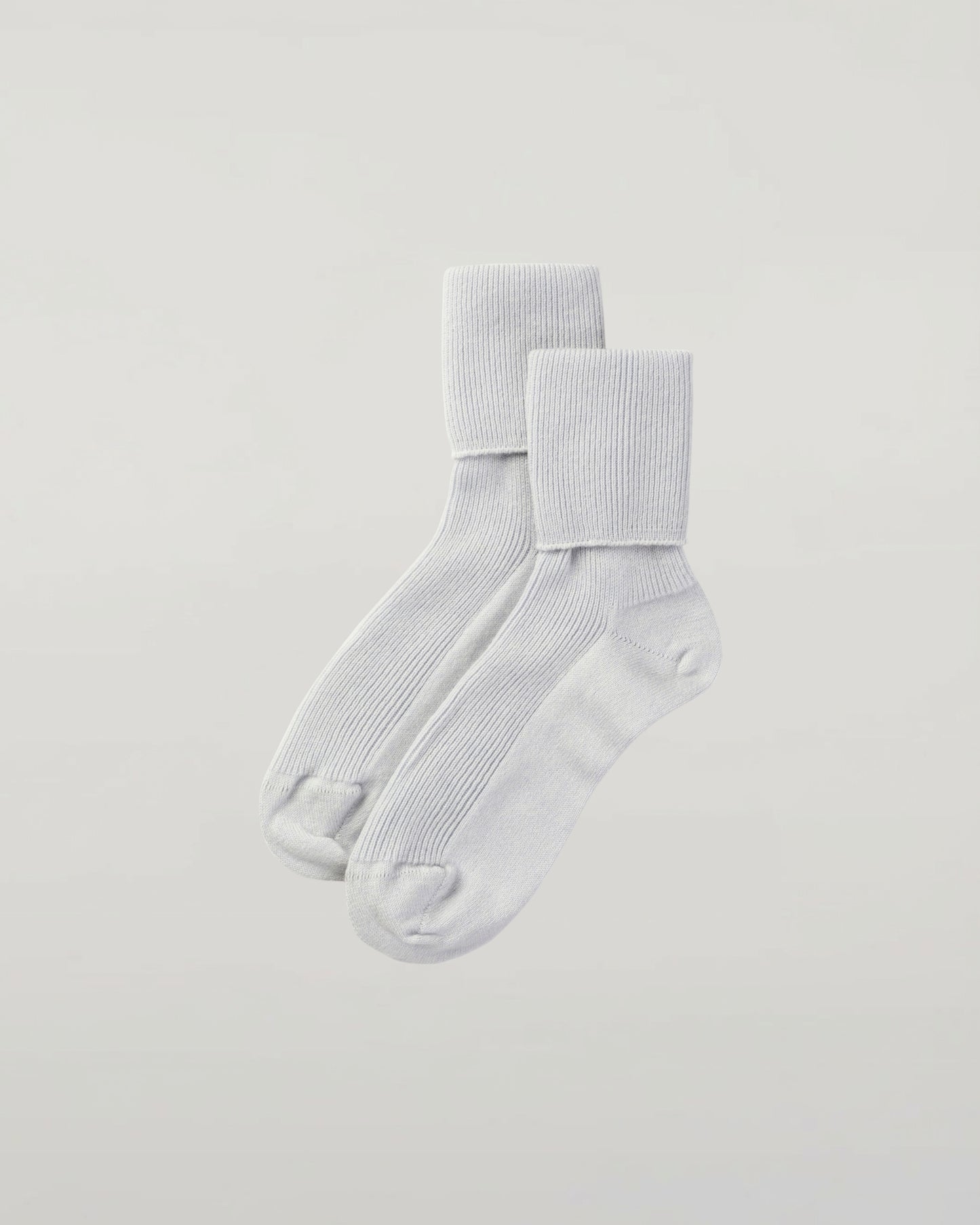 Johnstons of Elgin set of three pairs of cashmere socks in light blue, white, and navy on a white background 2025GIFTSET3B