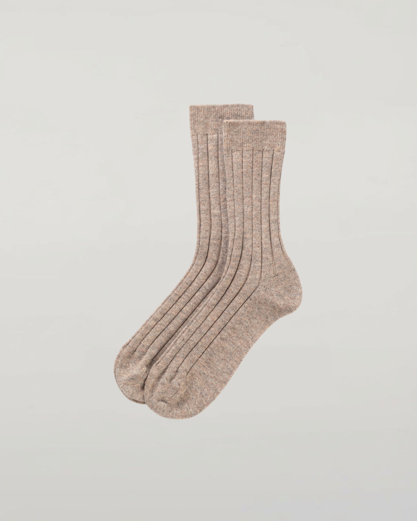 Johnstons of Elgin set of three pairs of cashmere socks in grey, navy, and beige on a light grey background 2025GIFTSET2