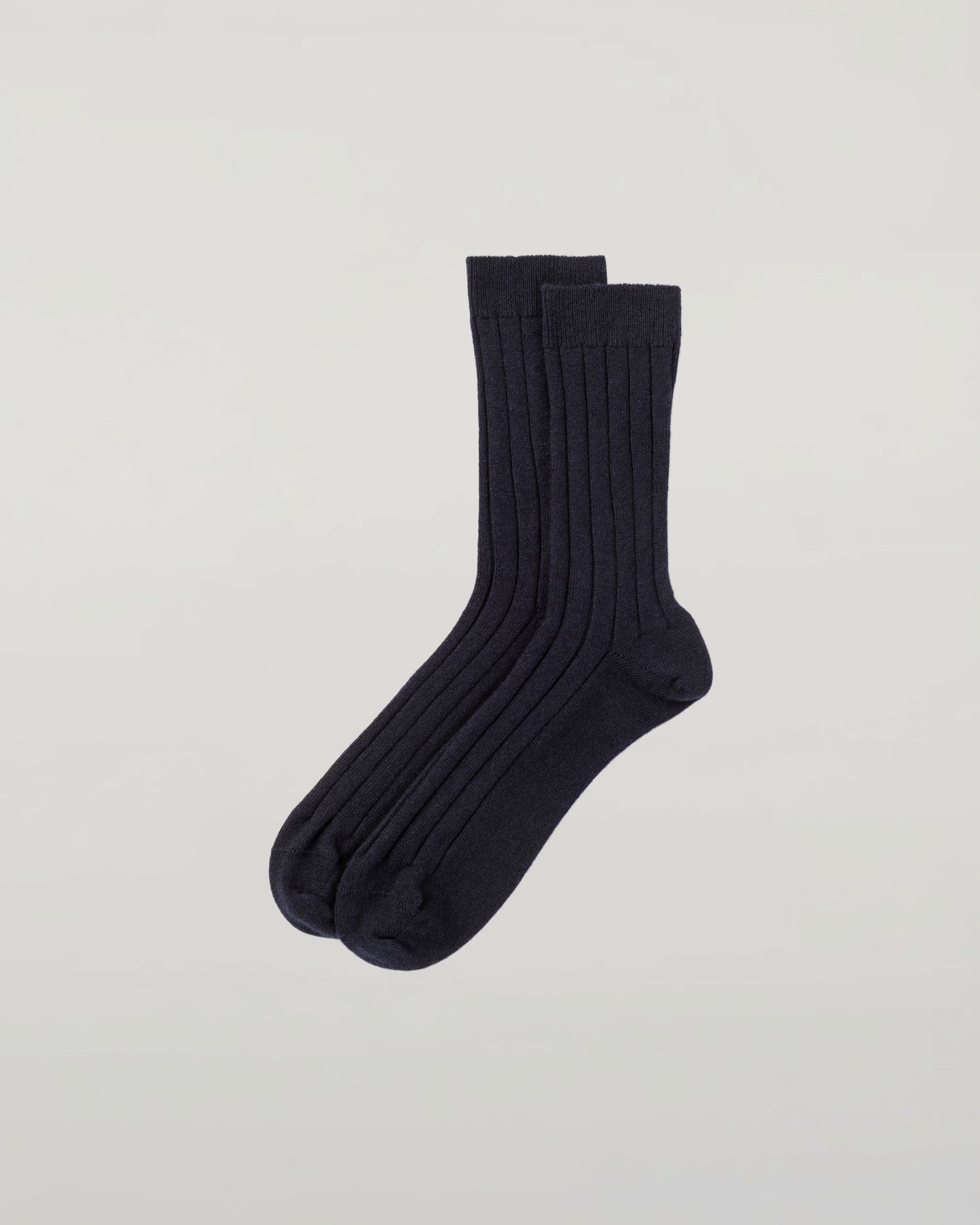 Johnstons of Elgin set of three pairs of cashmere socks in grey, navy, and beige on a light grey background 2025GIFTSET2