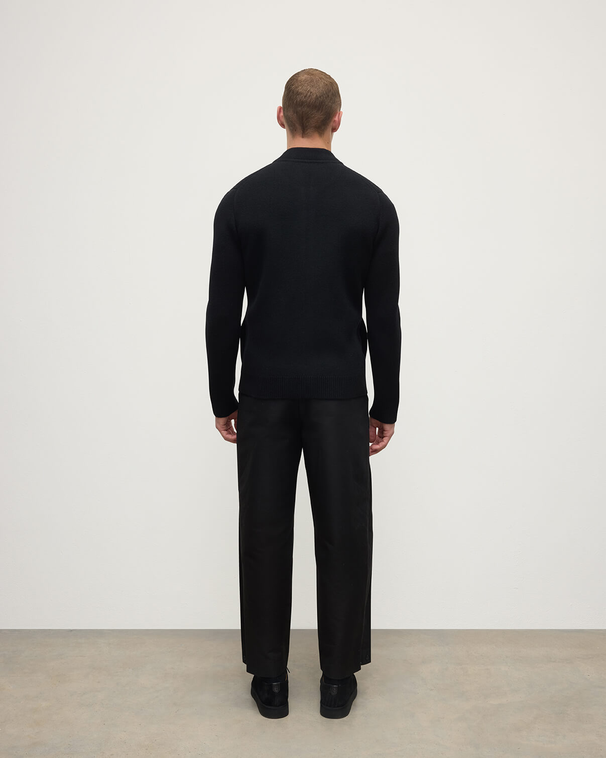 Back view of a model wearing Johnstons of Elgin Men's Knitwear Black Milano Ribbed Zip Black Cashmere  KAA05443SA7210