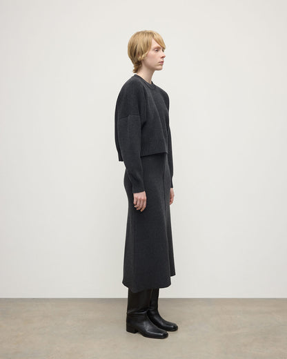 Model wearing Johnstons of Elgin AW25 Women's Knitwear Charcoal A-Line Milano Grey Cashmere Skirt Side View KAA05600HA7165