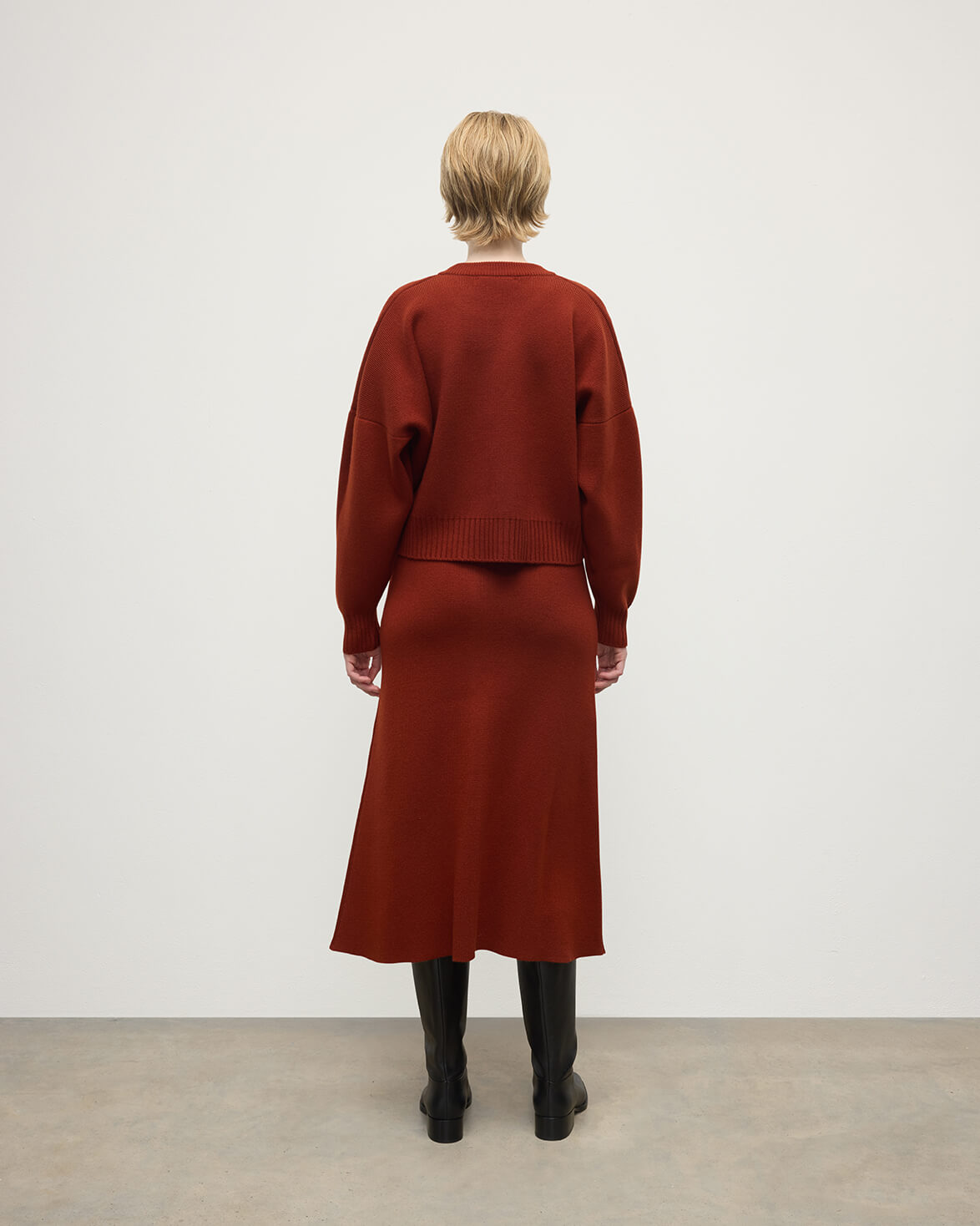 Model wearing Johnstons of Elgin AW25 Women's Knitwear Oxblood Cropped Milano Red Cashmere Jumper Back View KAA05488SG4463