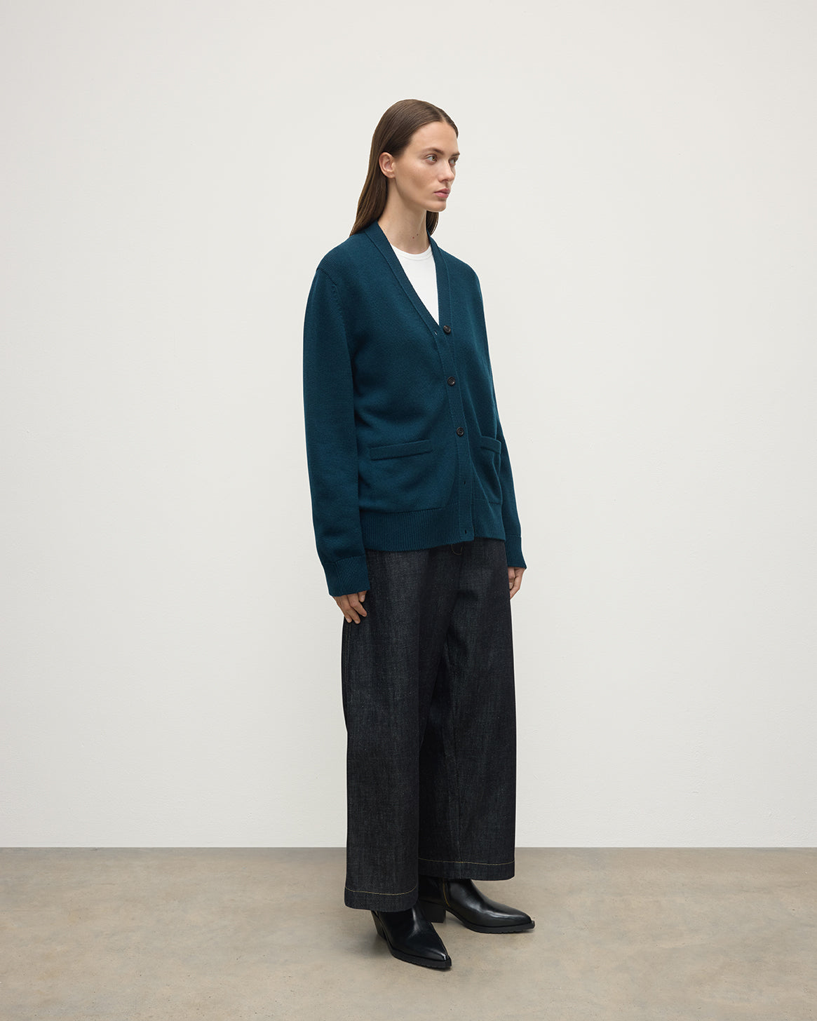 Model wears Johnstons of Elgin AW25 Women's Knitwear Bottle Green Boyfriend-Fit Green Cashmere Cardigan  Side View KAA05560SC7341