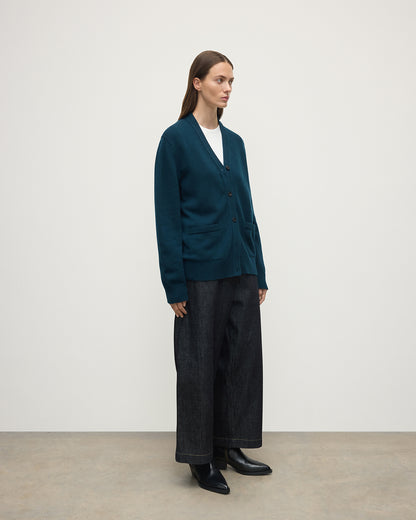 Model wears Johnstons of Elgin AW25 Women's Knitwear Bottle Green Boyfriend-Fit Green Cashmere Cardigan  Side View KAA05560SC7341
