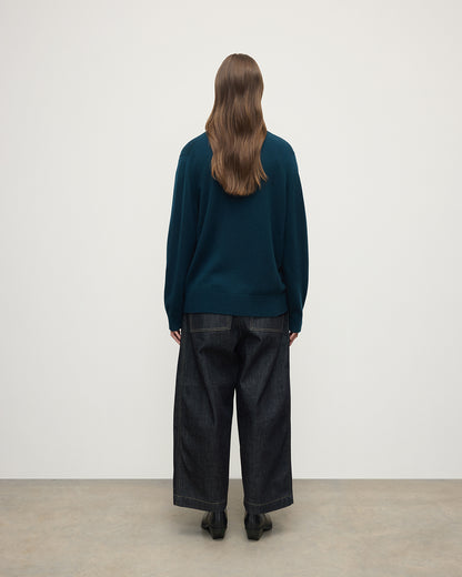 Model wears Johnstons of Elgin AW25 Women's Knitwear Bottle Green Boyfriend-Fit Green Cashmere Cardigan  Back View KAA05560SC7341