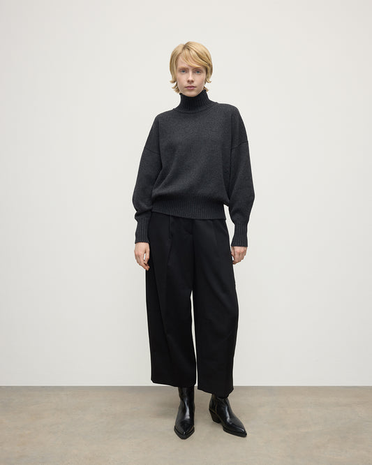 Model wearing Johnstons of Elgin AW25 Women's Knitwear Charcoal High Neck Grey Cashmere Jumper Front View KAA05585HA7165