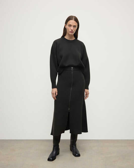 Model wearing Johnstons of Elgin AW25 Women's Knitwear Iron A-Line Milano Grey Cashmere Skirt Front View KAA05600SC7330