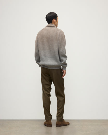 MALE MODEL WEARING JOHNSTONS OF ELGIN PIONEER SHAWL CARDIGAN GREY 100% CASHMERE WITH OLIVE GREEN CHINOS, OVER A SUPERFINE CASHMERE LIGHT BROWN SWEATER AND WHITE T-SHIRT KAA05750Q25948