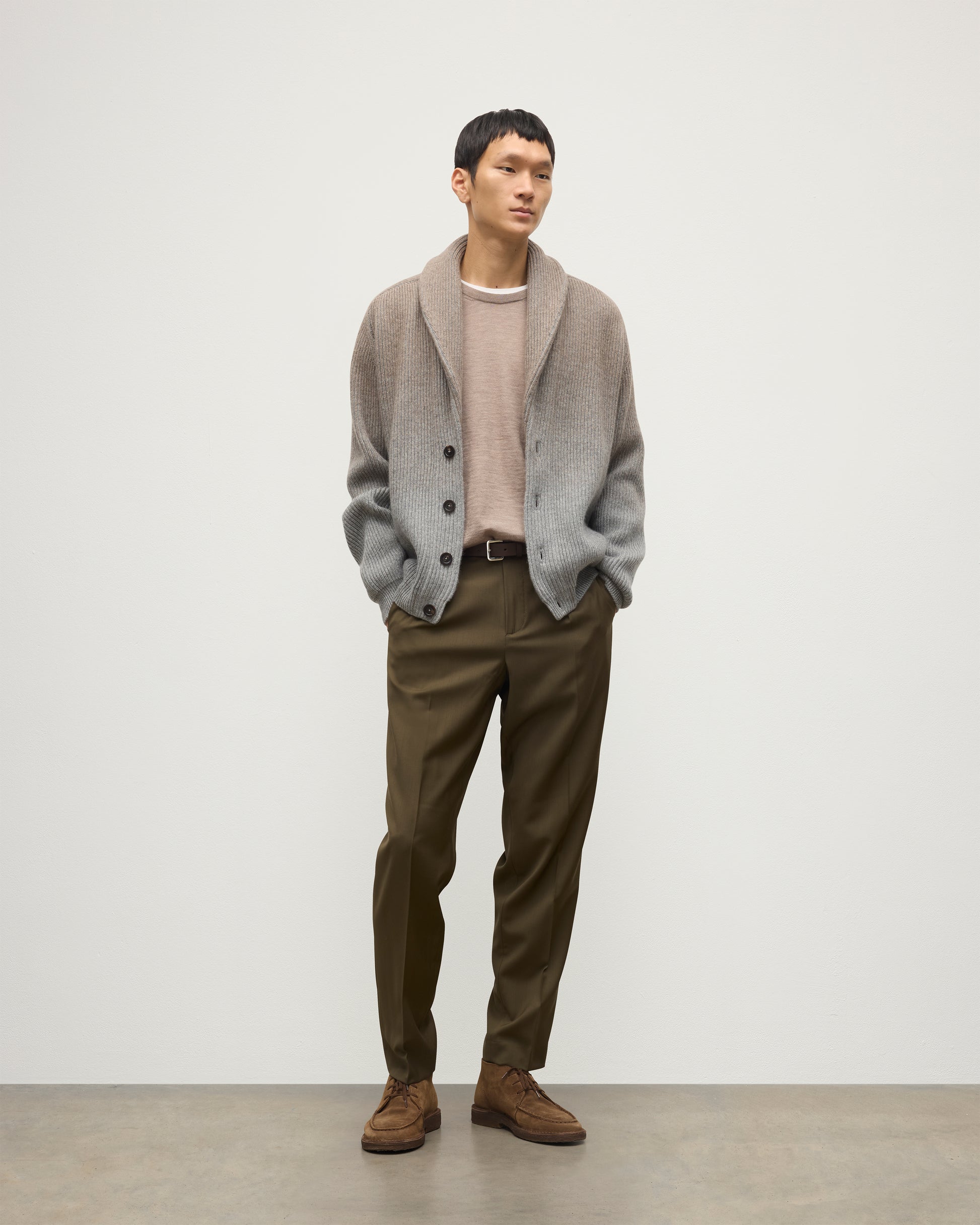 MALE MODEL WEARING JOHNSTONS OF ELGIN PIONEER SHAWL CARDIGAN GREY 100% CASHMERE WITH OLIVE GREEN CHINOS, WHITE T-SHIRT KAA05750Q25948