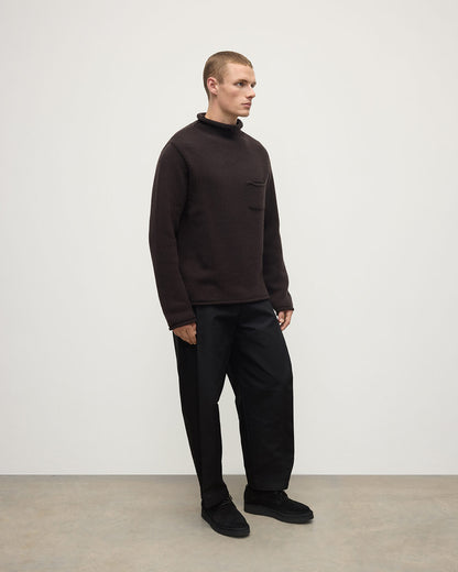 Side view of a model wearing Johnstons of Elgin AW25 Men's Knitwear Molasses Brown Cashmere Turtleneck Jumper KAB05484SB7290