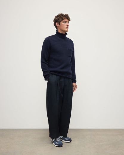 Side view of a model wearing Johnstons of Elgin Men's Knitwear Dark Navy Navy Cashmere Turtleneck Jumper KAB05484SD7666