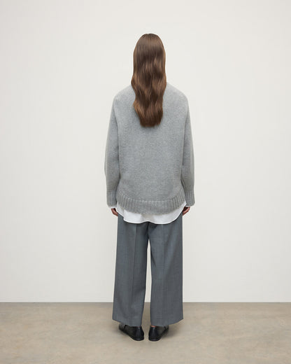 Model wearing Johnstons of Elgin AW25 Women's Knitwear Light Grey Relaxed Grey Cashmere Jumper Back View KAB05562HA0308