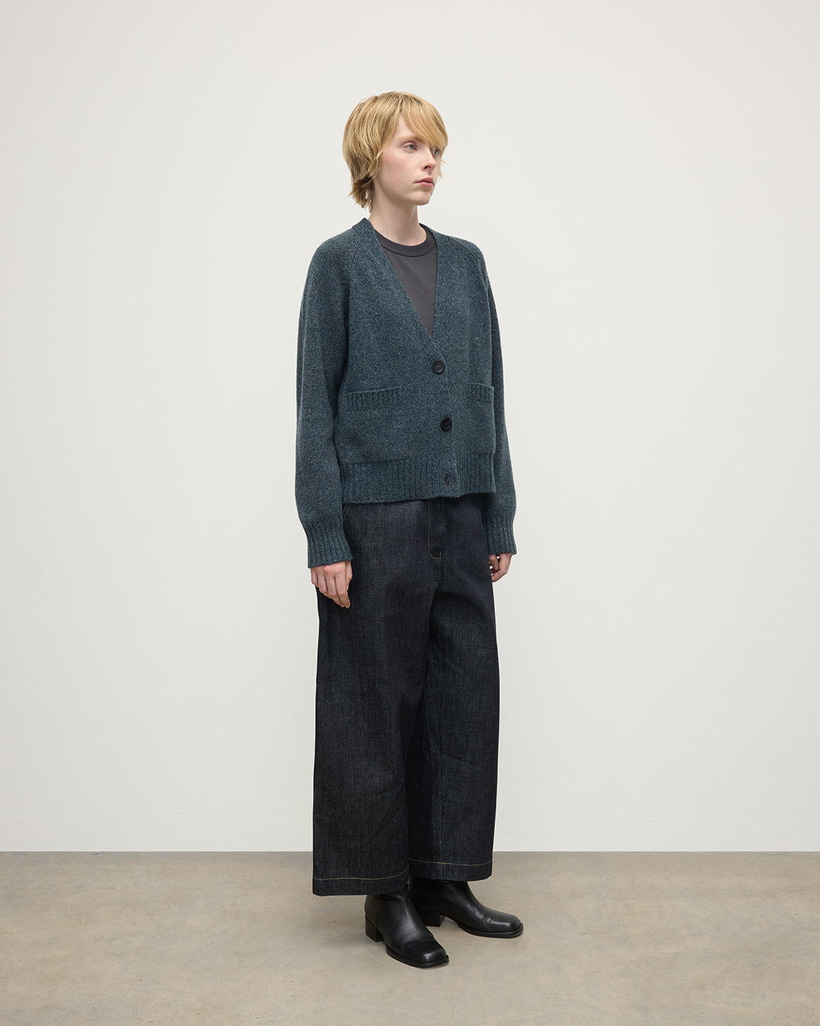 Model wearing Johnstons of Elgin AW25 Women's Knitwear Storm Donegal Donegal Cashmere Blue V Neck Cardigan Side View KAC05090006336