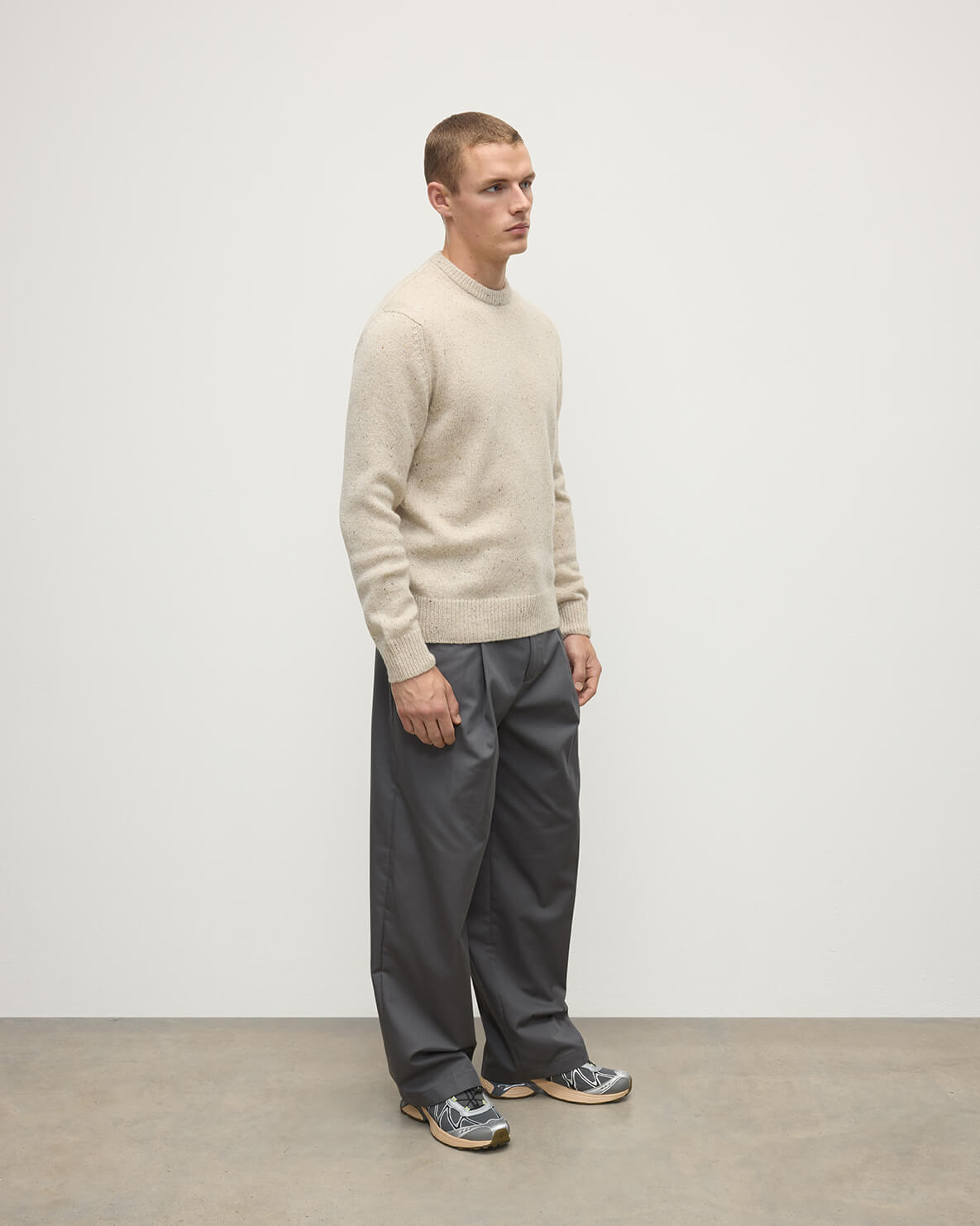 Model wears Johnstons of Elgin AW25 Men's Knitwear Cream Dun Donegal Cream Donegal Cashmere Marl Jumper Side KAC05287006334
