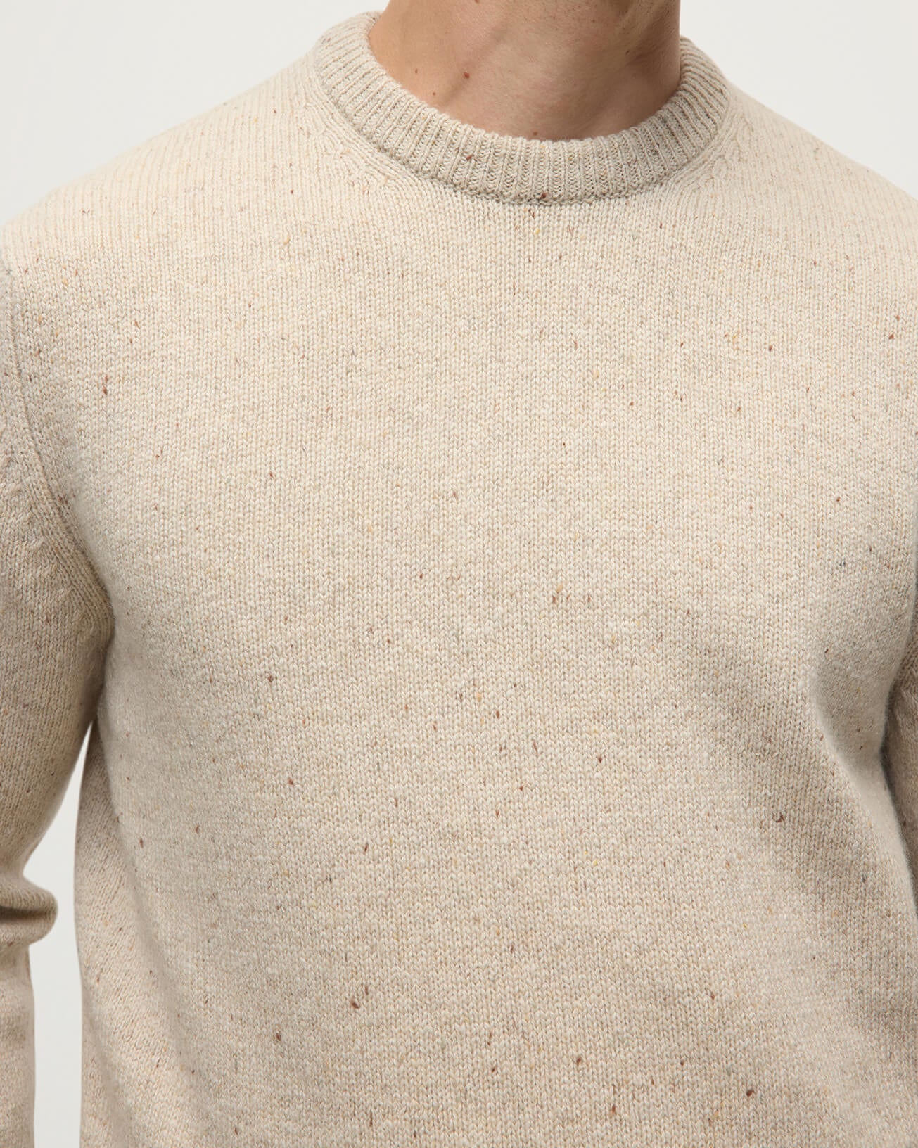 Model wears Johnstons of Elgin AW25 Men's Knitwear Cream Dun Donegal Cream Donegal Cashmere Marl Jumper Close up KAC05287006334