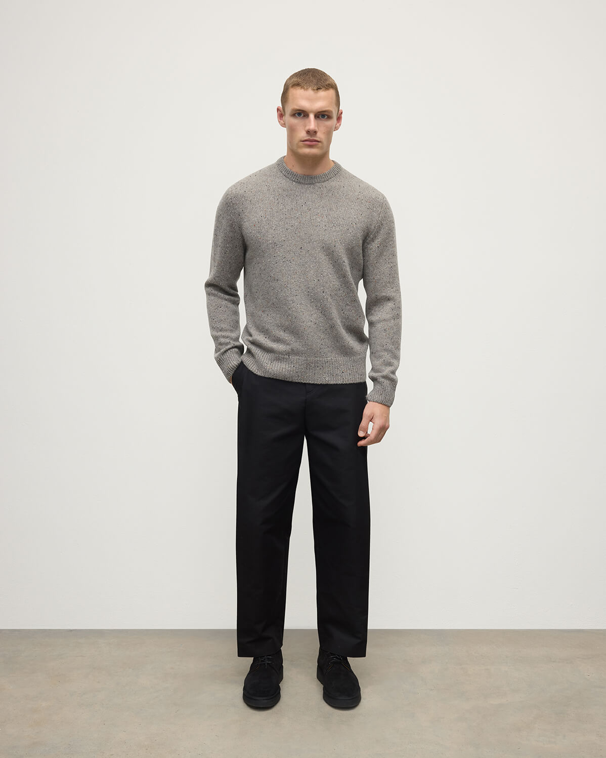 Model wearing Johnstons of Elgin AW25 Men's Knitwear Peregrine Donegal Grey Donegal Cashmere Marl Jumper Front  KAC05287006335