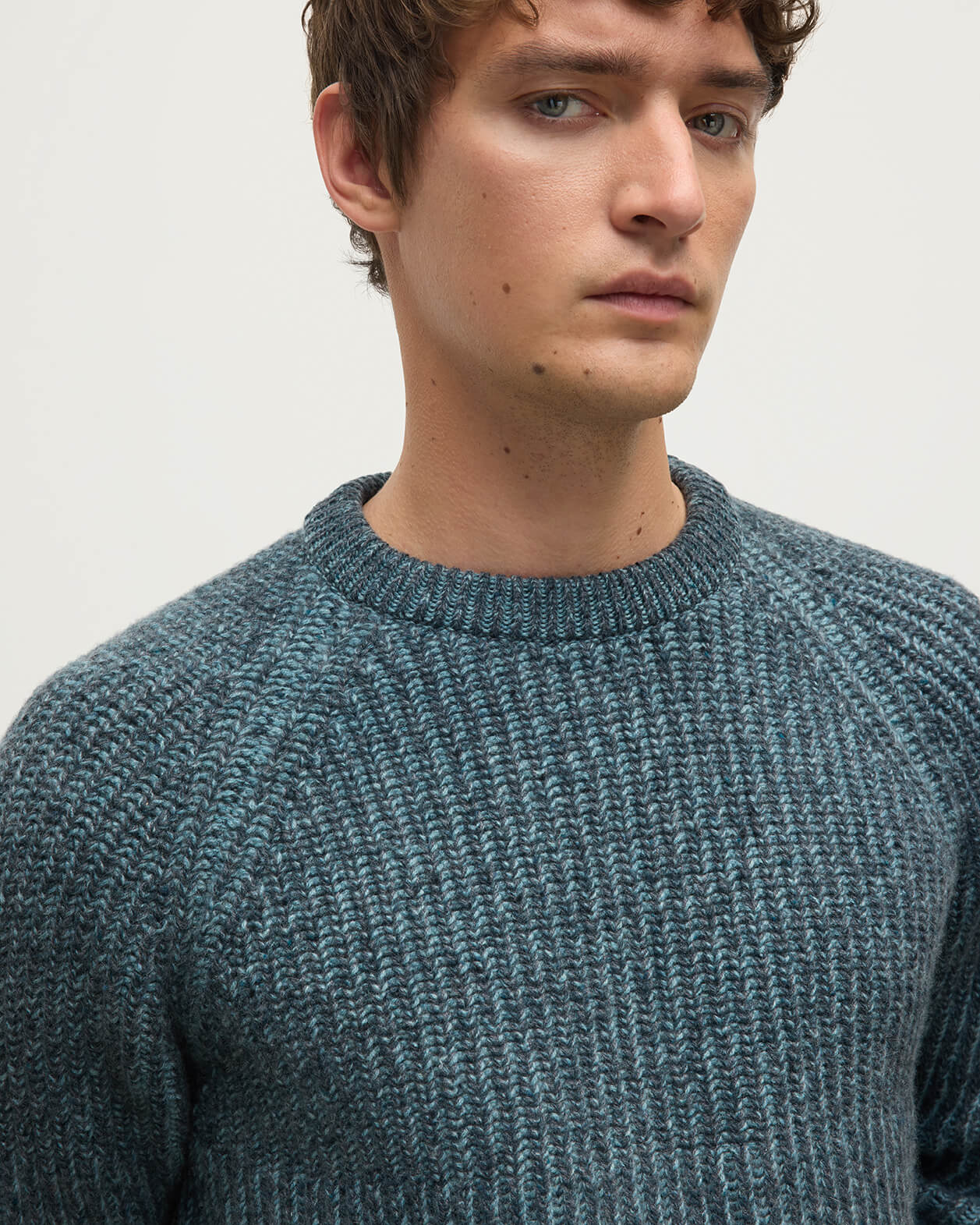 Model wears Johnstons of Elgin AW25 Men's Knitwear Storm Donegal & Seascape Ribbed Donegal Cashmere Blue Jumper Details  KAC05581Q25392