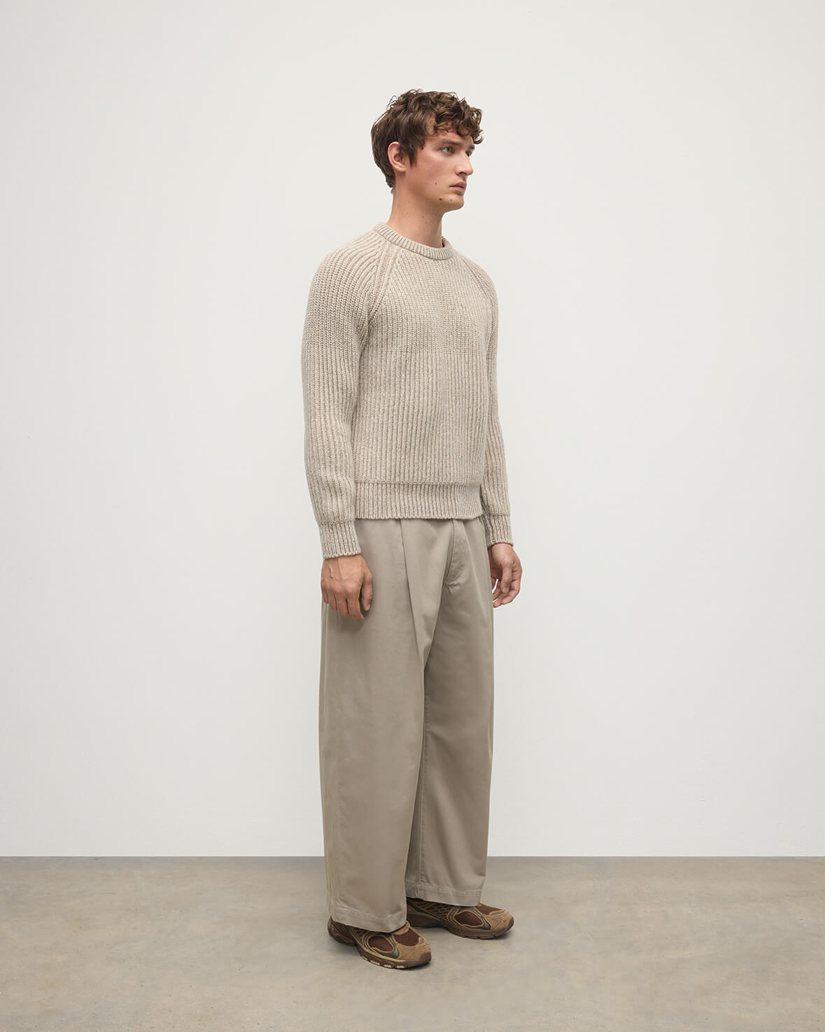 Side view of a model wearing Johnstons of Elgin AW25 Men's Knitwear Cream Dun Donegal & Ash Ribbed Donegal Cashmere Cream Jumper KAC05581Q25394