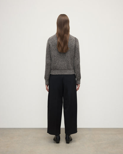Model wearing Johnstons of Elgin AW25 Women's Knitwear Peregrine Donegal & Molasses High Neck Donegal Cashmere Brown Jumper Back View KAC05590Q25393