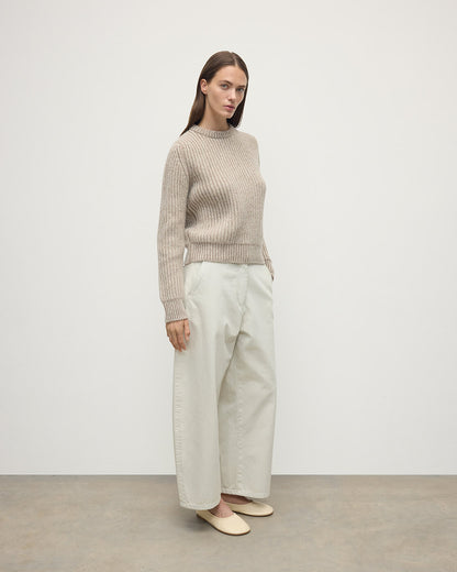 Model wearing Johnstons of Elgin AW25 Women's Knitwear Cream Dun Donegal & Ash High Neck Donegal Cashmere Cream Jumper Side View  KAC05590Q25394
