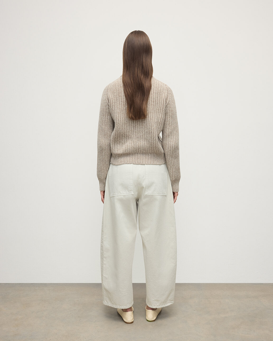 Model wearing Johnstons of Elgin AW25 Women's Knitwear Cream Dun Donegal & Ash High Neck Donegal Cashmere Cream Jumper Back View  KAC05590Q25394