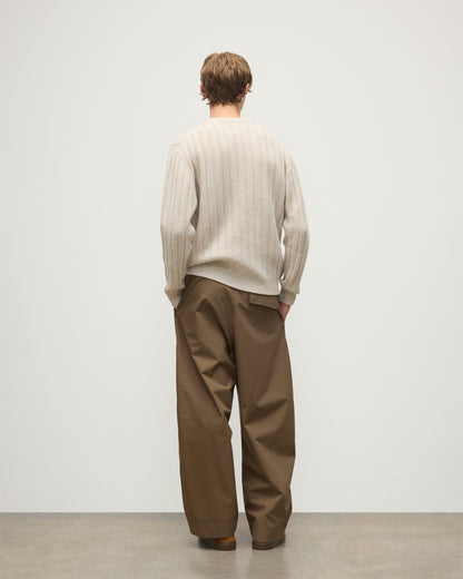 JOHNSTONS OF ELGIN MENS PEEL CREW SWEATER NATURAL 100% CASHMERE ON A MODEL OVER A WHITE T-SHIRT WITH BROWN TROUSERS KAC05751HA0402