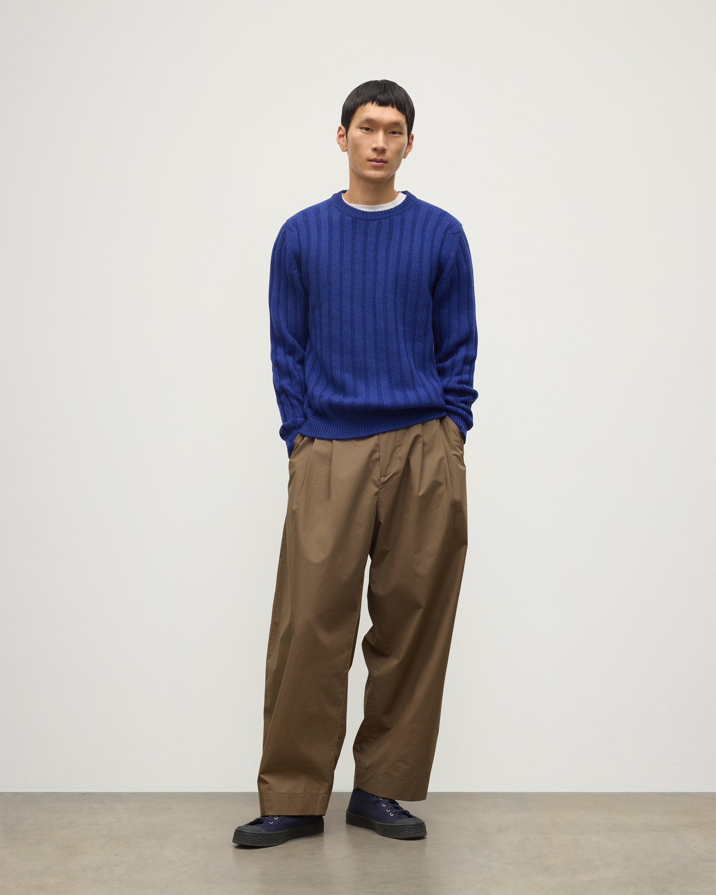 JOHNSTONS OF ELGIN MENS PEEL CREW SWEATER BLUE ON A MODEL OVER A WHITE T-SHIRT AND BROWN TROUSERS KAC05751SD5326