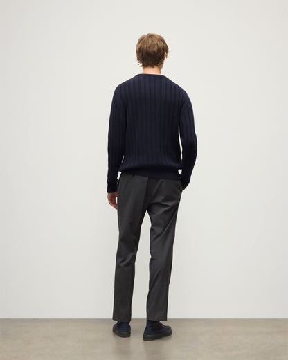 MODEL WEARS JOHNSTONS OF ELGIN MENS PEEL CREW SWEATER NAVY OVER A WHITE T-SHIRT WITH GREY TROUSERS KAC05751SD7666