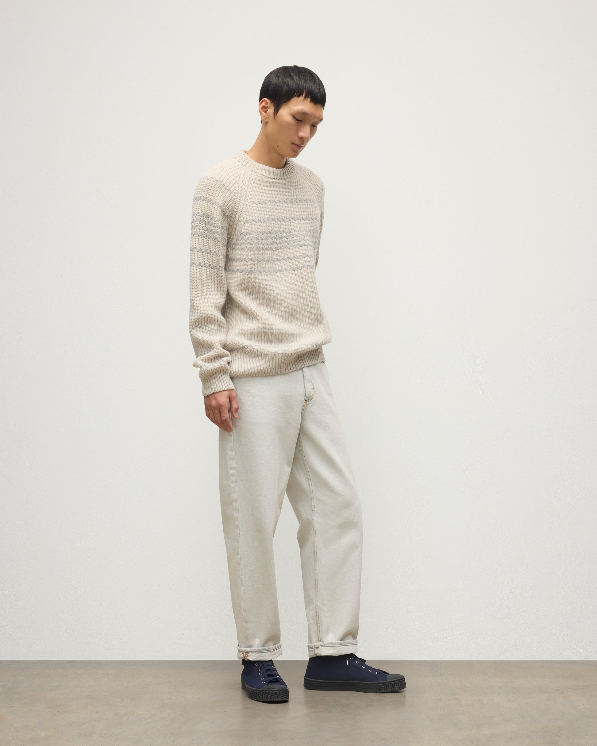 MODEL WEARING JOHNSTONS OF ELGIN MENS SUMMIT CREW SWEATER NATURAL & GREY 100% CASHMERE WITH CREAM JEANS KAC05752Q25975