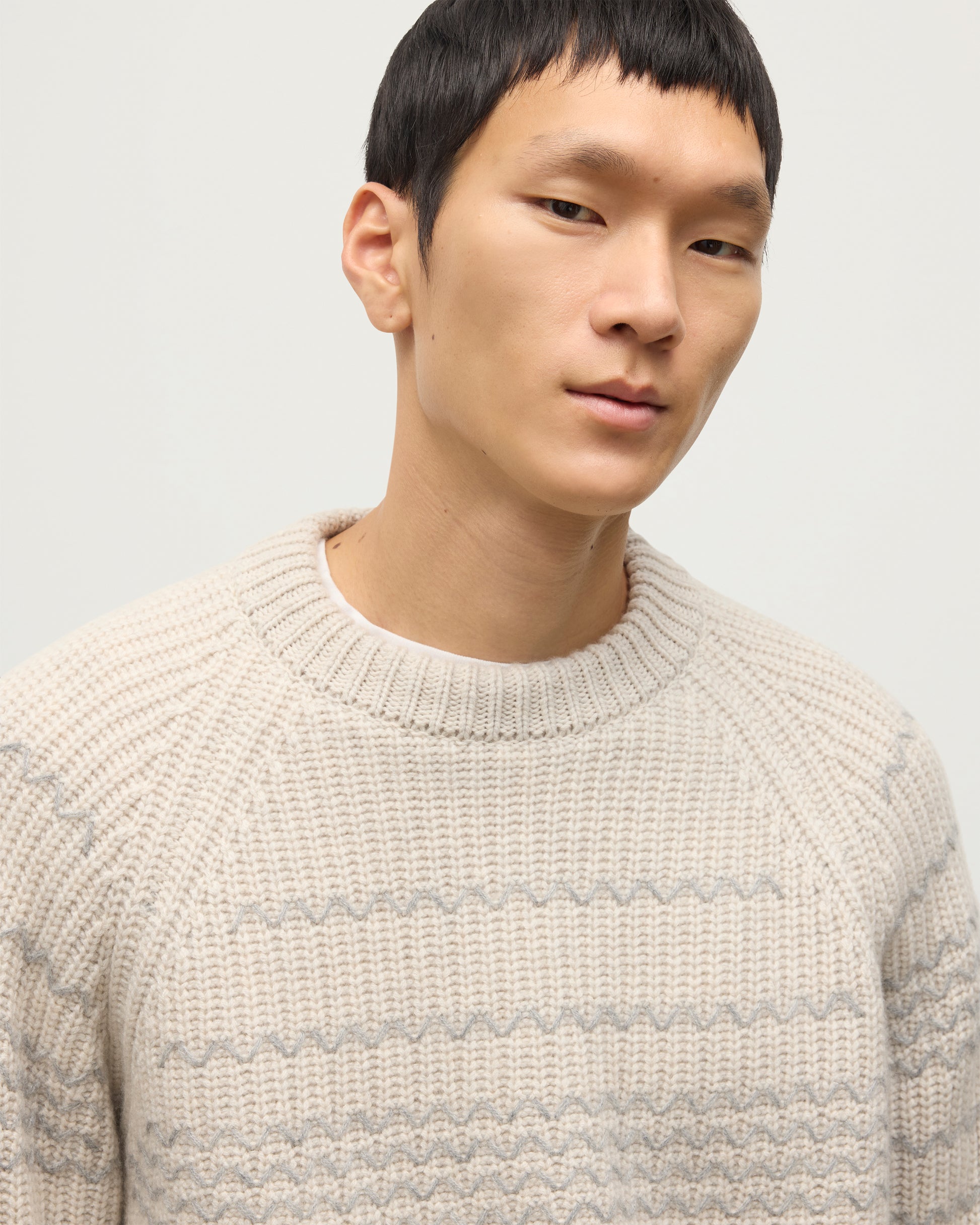 MODEL WEARING JOHNSTONS OF ELGIN MENS SUMMIT CREW SWEATER NATURAL & GREY 100% CASHMERE WITH CREAM JEANS KAC05752Q25975