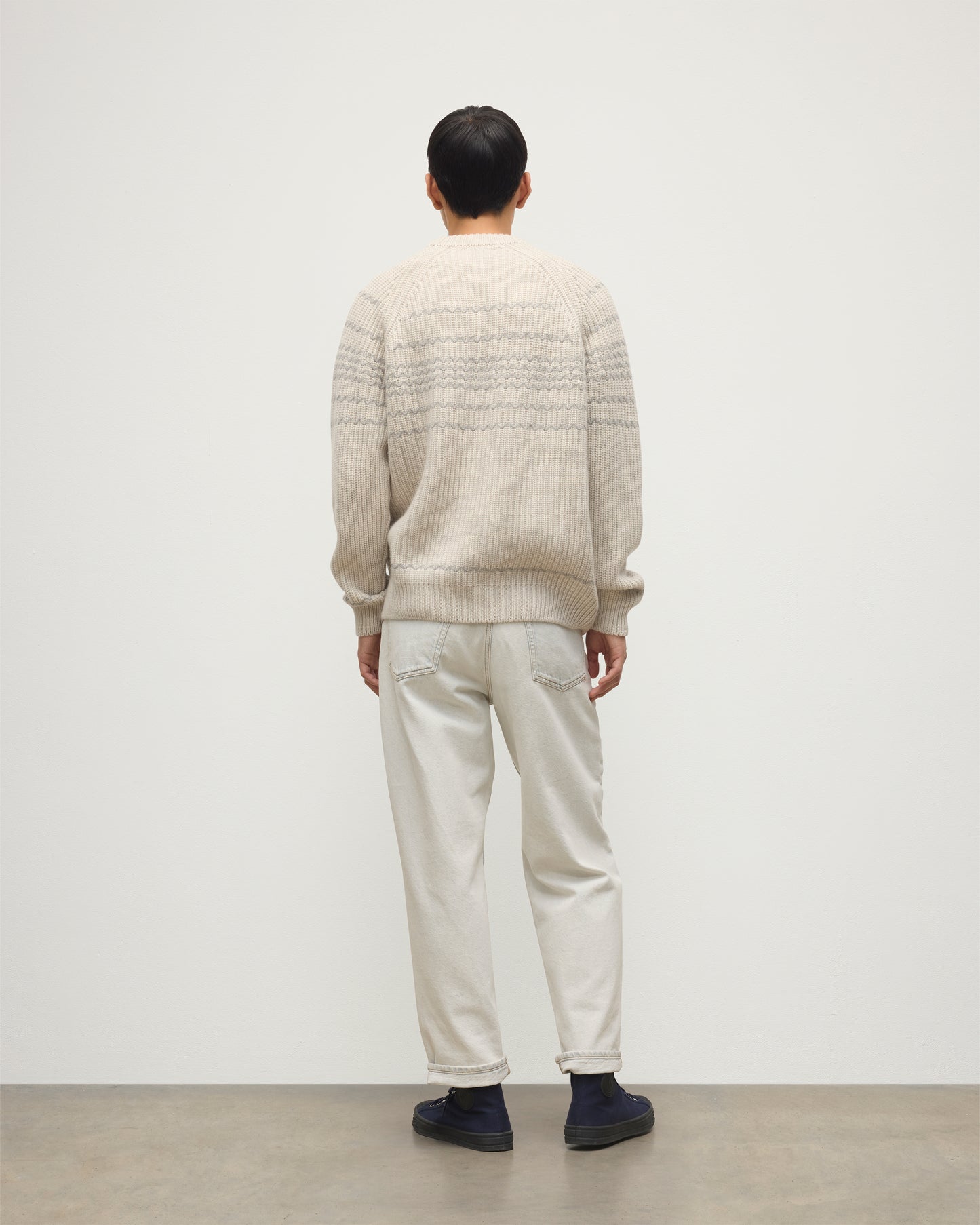 MODEL WEARING JOHNSTONS OF ELGIN MENS SUMMIT CREW SWEATER NATURAL & GREY 100% CASHMERE WITH CREAM JEANS KAC05752Q25975