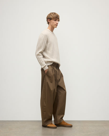 JOHNSTONS OF ELGIN MENS PEEL CREW SWEATER NATURAL 100% CASHMERE ON A MODEL OVER A WHITE T-SHIRT WITH BROWN TROUSERS KAC05751HA0402