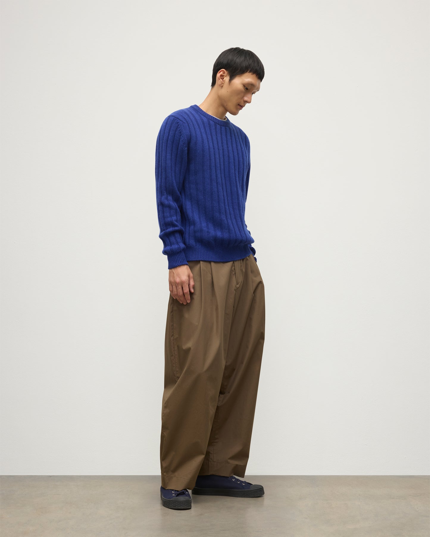 JOHNSTONS OF ELGIN MENS PEEL CREW SWEATER BLUE ON A MODEL OVER A WHITE T-SHIRT AND BROWN TROUSERS KAC05751SD5326