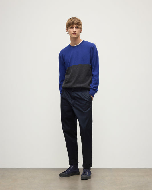 MODEL WEARING JOHNSTONS OF ELGIN MENS SHADED CREW SWEATER GREY 100% CASHMERE OVER A WHITE  T-SHIRT WITH NAVY TROUSERS KAI05232Q25945