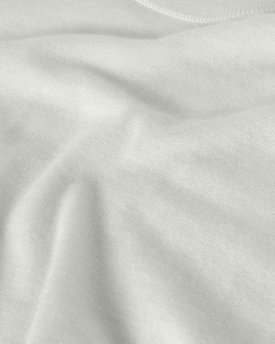 Johnstons of Elgin AW25 Men's Knitwear White Superfine Cashmere V Neck Jumper  against a white backdrop  KAI05242HA0327