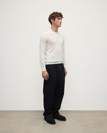 model wearing Johnstons of Elgin AW25 Men's Knitwear White Superfine Cashmere V Neck Jumper  against a white backdrop  KAI05242HA0327