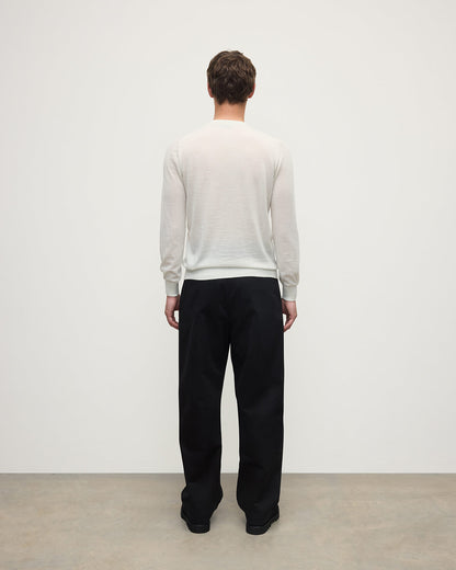 model wearing Johnstons of Elgin AW25 Men's Knitwear White Superfine Cashmere V Neck Jumper  against a white backdrop  KAI05242HA0327