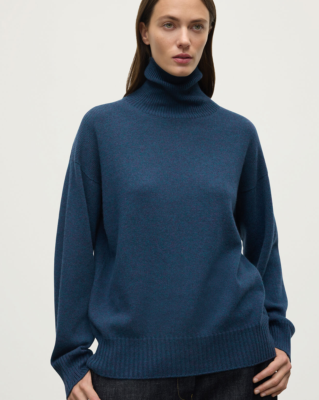 Model wears Johnstons of Elgin AW25 Women's Knitwear Heather Navy Gauzy Cashmere Roll Neck Close up KAI05324HD7321