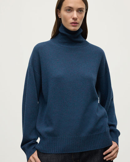Model wears Johnstons of Elgin AW25 Women's Knitwear Heather Navy Gauzy Cashmere Roll Neck Close up KAI05324HD7321