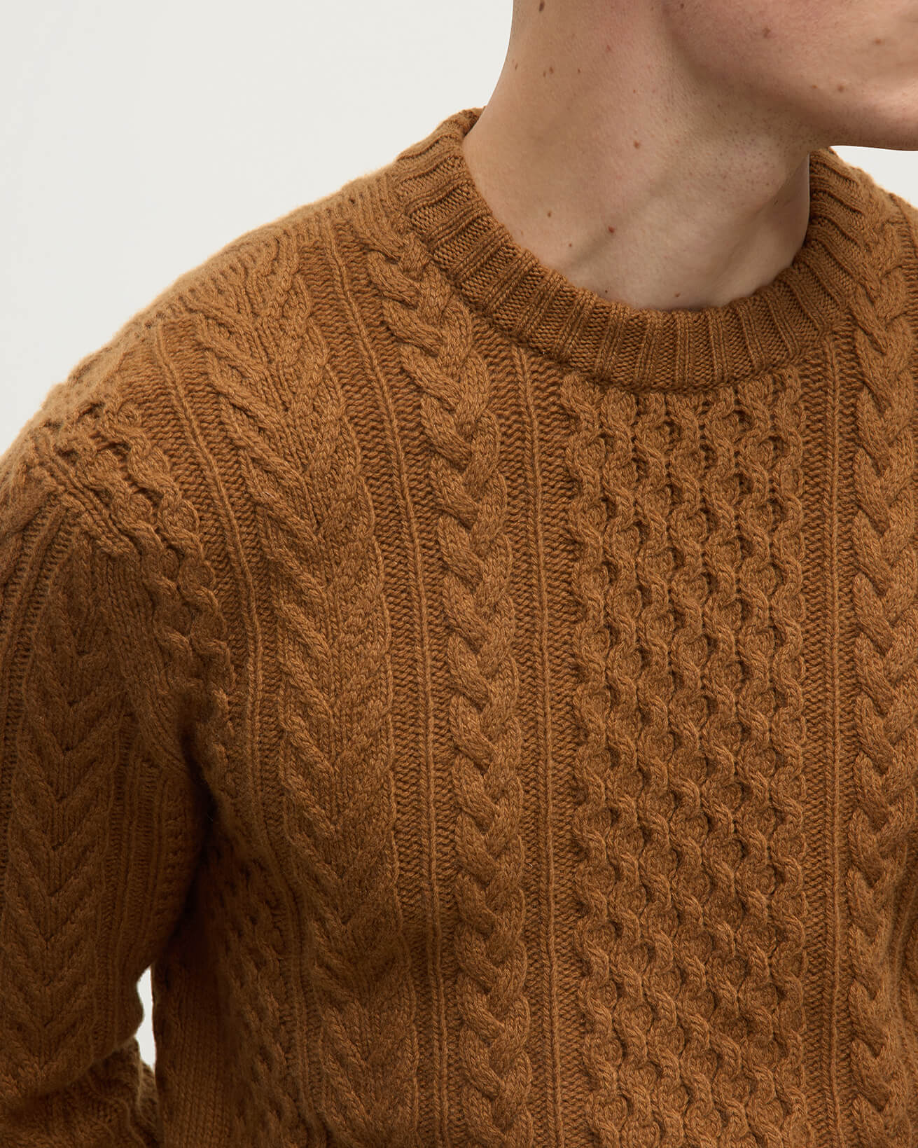 Details of model wearing Johnstons of Elgin AW25 Men's Knitwear Dark Camel Aran Cable Camel Cashmere Jumper KAI05336SB4620