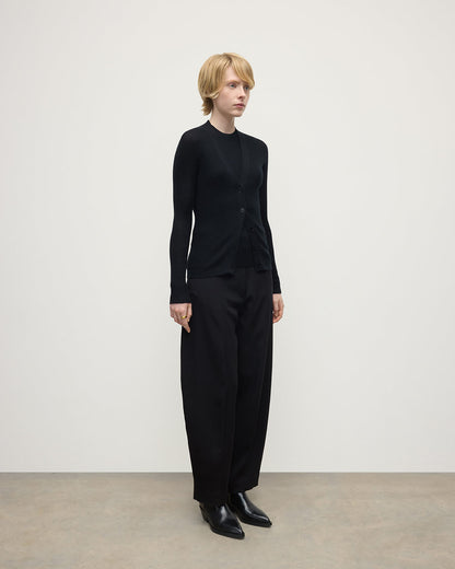 Model wears Johnstons of Elgin AW25 Women's Knitwear Black Superfine Cashmere Black Cardigan Side View KAI05372SA7146