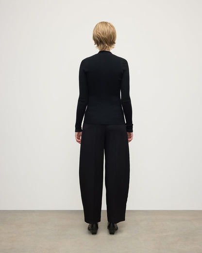 Model wears Johnstons of Elgin AW25 Women's Knitwear Black Superfine Cashmere Black Cardigan Back View KAI05372SA7146