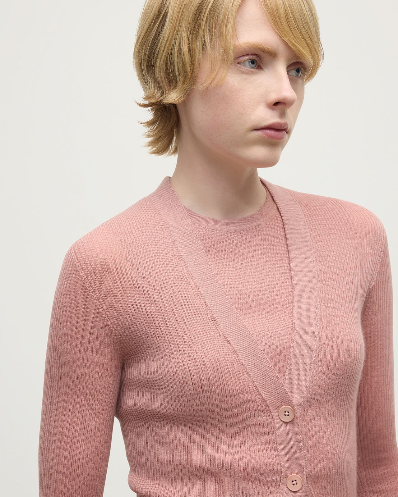 Model wears Johnstons of Elgin AW25 Women's Knitwear Nude Superfine Cashmere Pink Cardigan Neckline details KAI05372SE5274