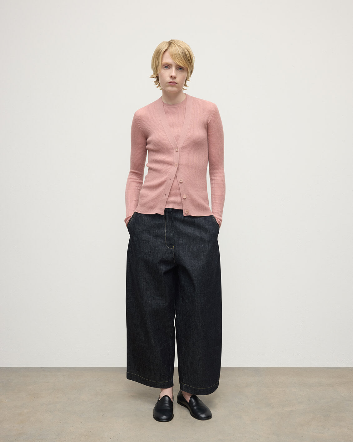Model wears Johnstons of Elgin AW25 Women's Knitwear Nude Superfine Cashmere Pink Cardigan Front View KAI05372SE5274