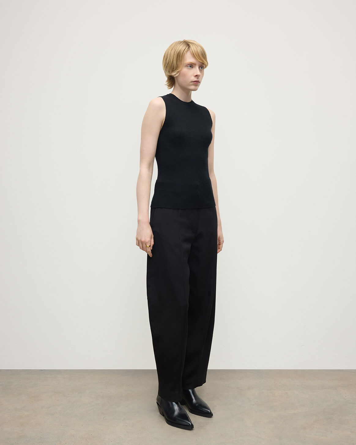 model wears Johnstons of Elgin AW25 Women's Knitwear Black Sleeveless Black Tank Top side view KAI05559SA7146
