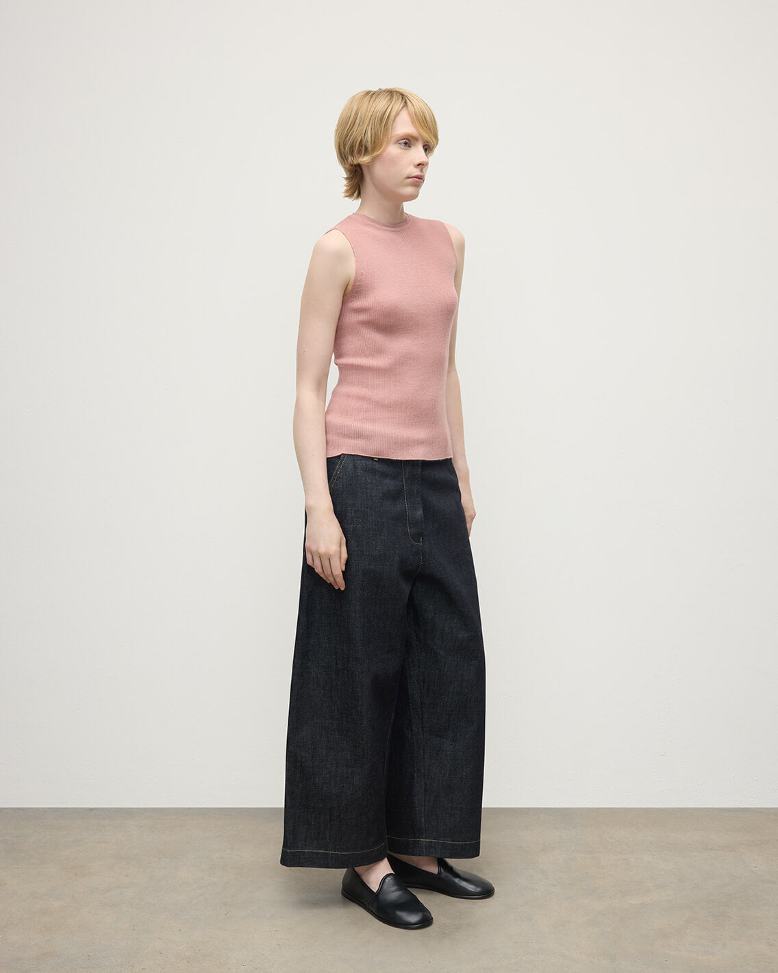 model wears Johnstons of Elgin AW25 Women's Knitwear Nude Sleeveless Pink Tank Top Side View KAI05559SE5274