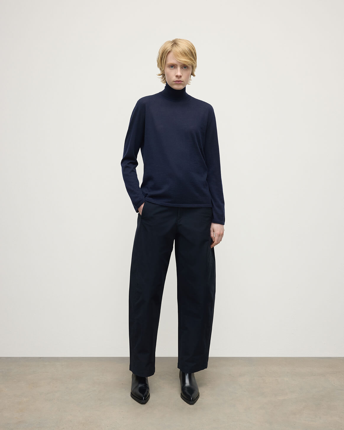 Model wears Johnstons of Elgin AW25 Women's Knitwear Dark Navy Superfine Cashmere Navy Roll Neck Jumper Front View KAI05607SD7600