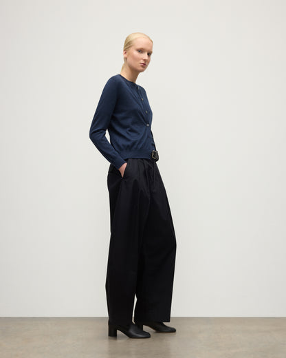 MODEL WEARS JOHHNSTONS OF ELGIN WOMENS HONOR CREW CARDIGAN NAVY 100% SUPERFINE CASHMERE OVER MATCHING CASHMERE T-SHIRT & BLACK TROUSERS KAI05708HD7350