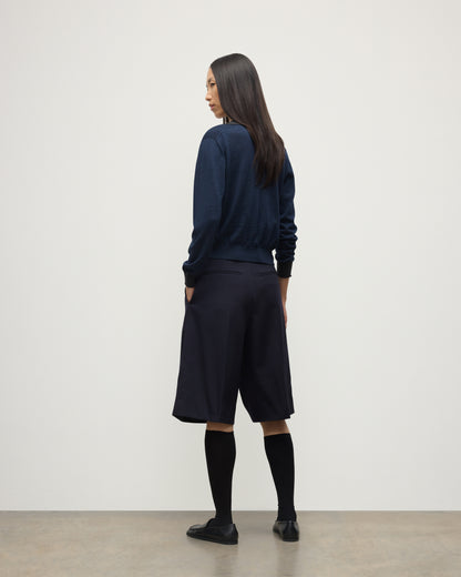 MODEL WEARS JOHNSTONS OF ELGIN WOMENS DEE SHIRT NAVY & GREY 100% SUPERFINE CASHMERE WITH NAVY LONG SHIRTS< SOCKS AND LOAFERS KAI05713Q25962